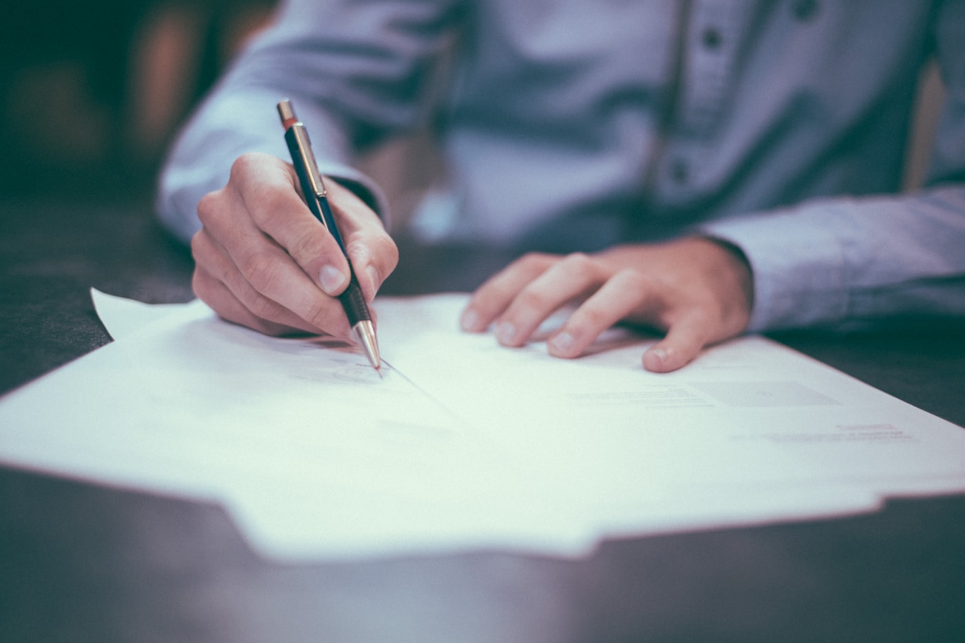 Writing on documents at a desk